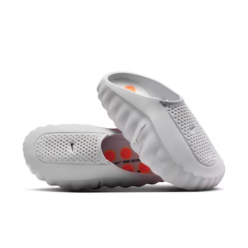 Pair of white Nike Mind 001 recovery shoes stacked, showing perforated upper